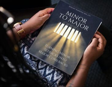 Minor to Major paperback book being held in the hands of a youth